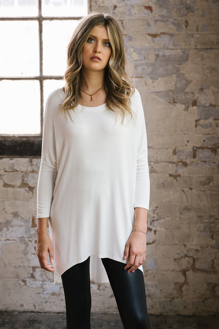Flirty Long Line Dipped Back Knit
Top