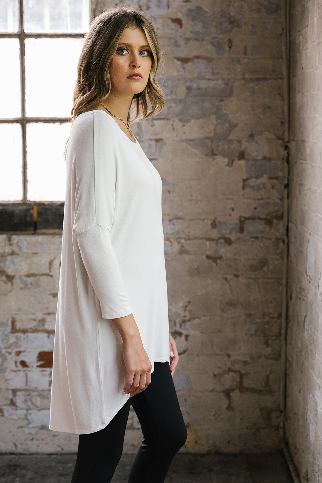 Flirty Long Line Dipped Back Knit
Top