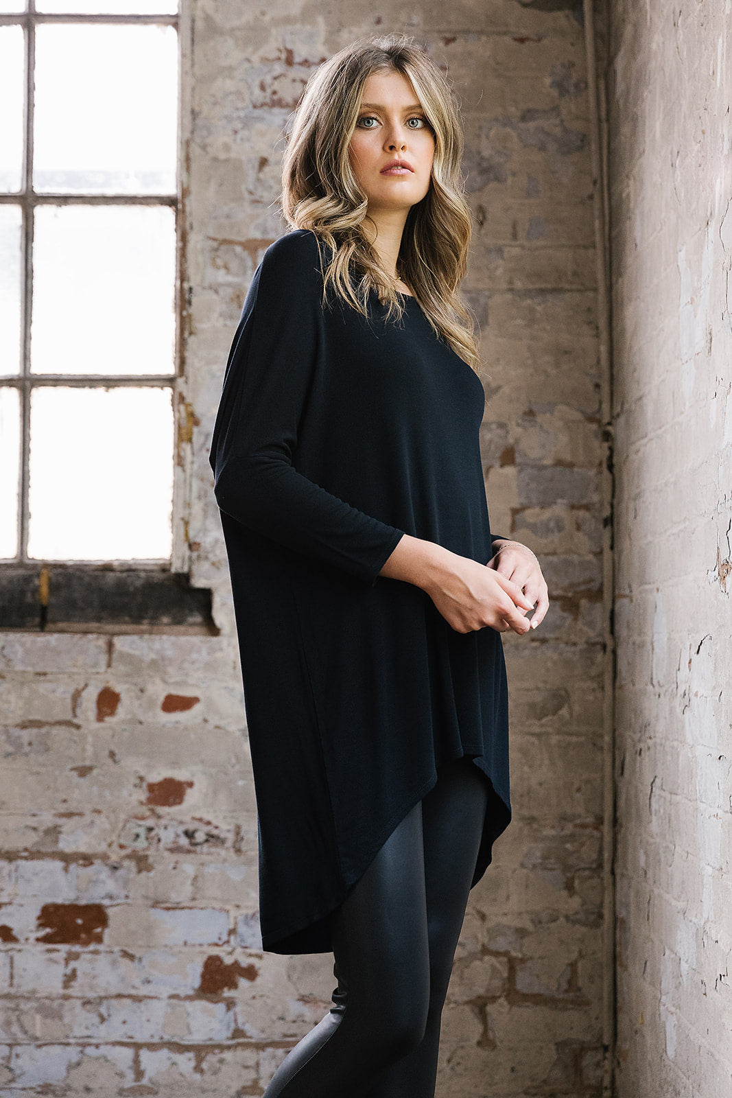 Flirty Long Line Dipped Back Knit
Top