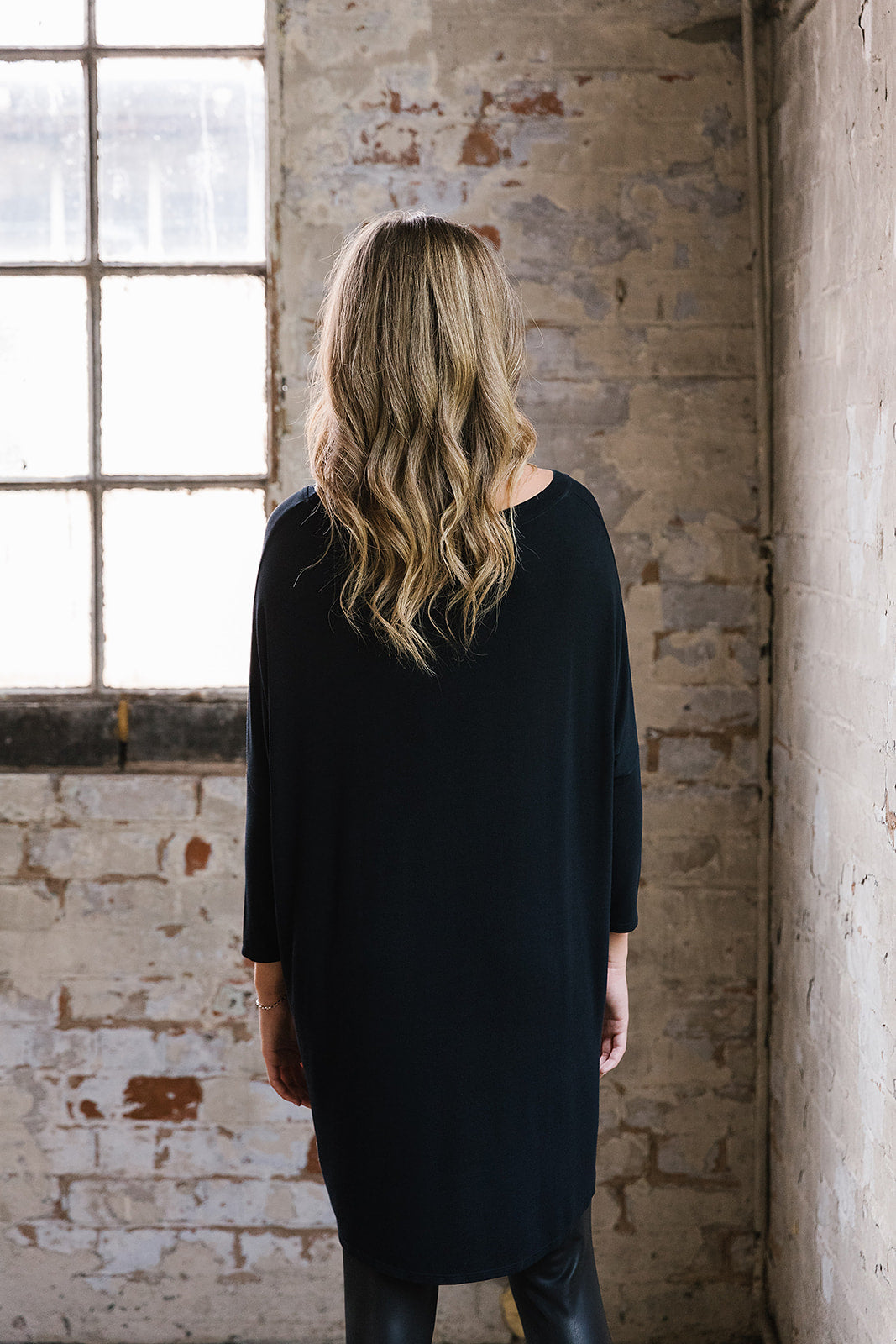 Flirty Long Line Dipped Back Knit
Top