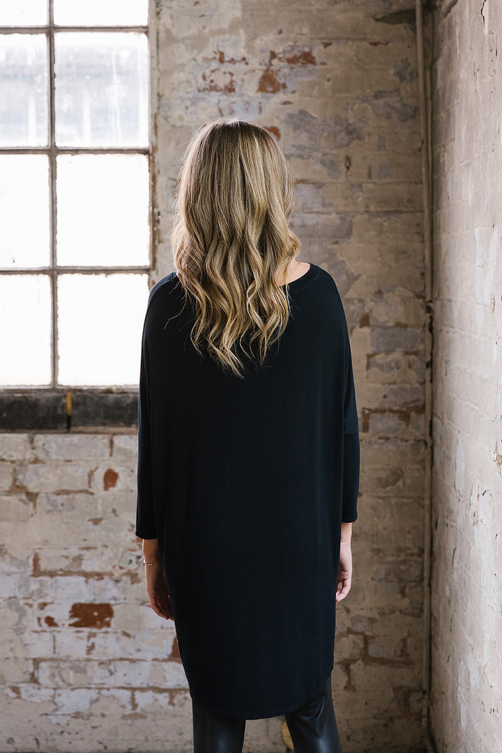 Flirty Long Line Dipped Back Knit
Top